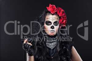 Serious woman in day of the dead mask portrait