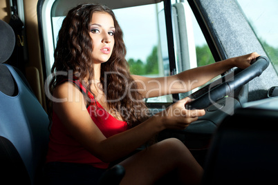 Young attractive girl drive big truck