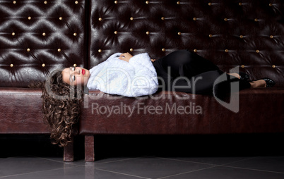 Beauty woman lay on leather sofa