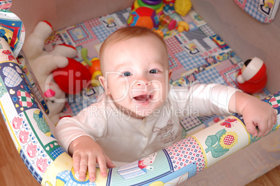 Smiling child playing in the cot, family scenes