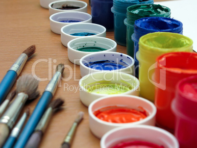 Brushes and paints on table