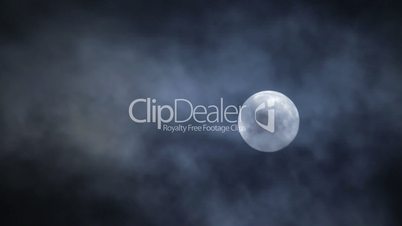 Full moon hiding by clouds on dark night sky background