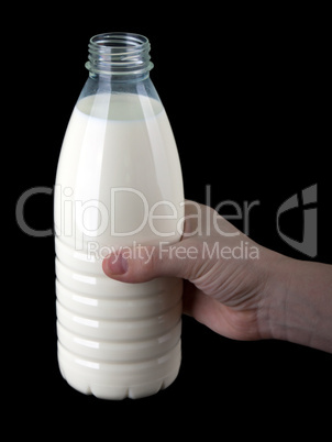 Hand holding milk bottle