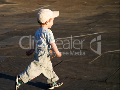 Little child playing soccer ball