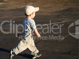 Little child playing soccer ball