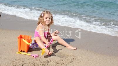 little girl playing and fun on the beach