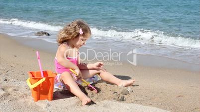 little girl playing on the beach