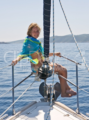 woman sitting on yacht nose