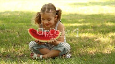 little girl eat watermelon
