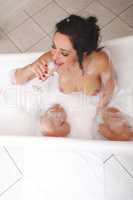 woman with champagne in a bathtub