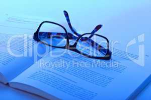 eyeglasses lie on the book