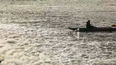 Alone fisher in boat