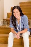 Home living happy woman sitting on staircase