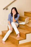 Home living happy woman work laptop staircase