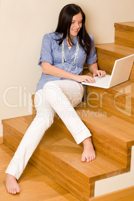 Home living happy woman work laptop staircase