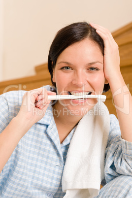 Home morning woman hold toothbrush in mouth