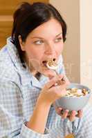Home breakfast happy woman pajamas eating cereals