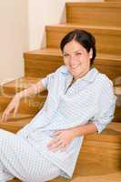 Home morning woman in pajamas on staircase