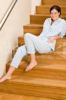 Home morning woman in pajamas on staircase