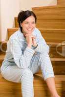 Home morning woman in pajamas on staircase