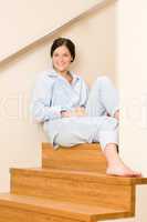 Home morning woman in pajamas on staircase