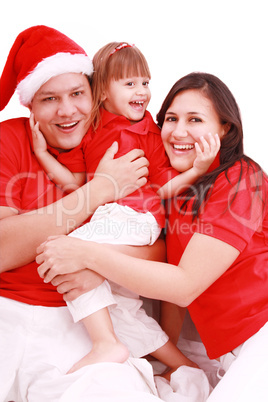 Portrait of happy family looking at camera and prepared for Chri