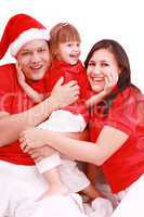 Portrait of happy family looking at camera and prepared for Chri