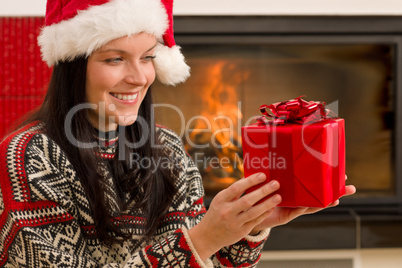 Christmas present woman Santa hat home fireplace