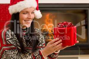 Christmas present woman Santa hat home fireplace