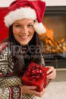 Christmas present woman Santa hat home fireplace