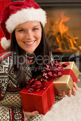 Christmas present woman Santa hat home fireplace