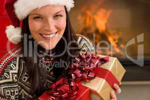 Christmas present woman Santa hat home fireplace