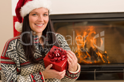 Christmas present woman Santa hat home fireplace