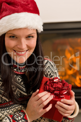 Christmas present woman Santa hat home fireplace