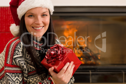 Christmas present woman Santa hat home fireplace