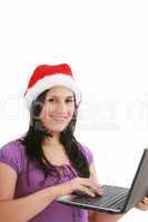 Beautiful business woman is working in office in santa claus hat