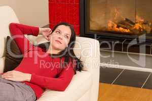 Woman on sofa by fireplace home living