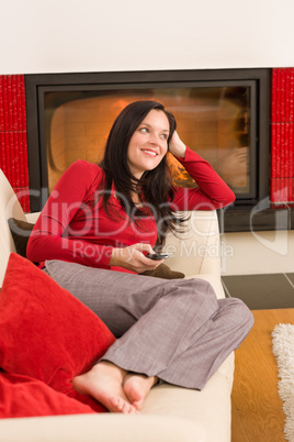 Fireplace woman with phone lying home sofa