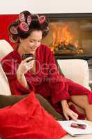 Home beauty woman with hair curlers drink