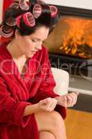 Home beauty woman manicure with hair curlers
