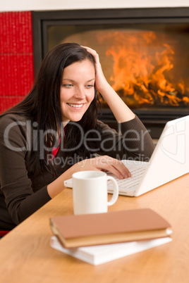 Home living woman with laptop by fireplace