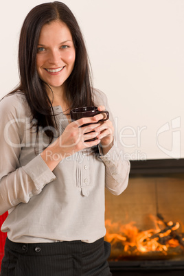 Winter home fireplace woman drink hot coffee