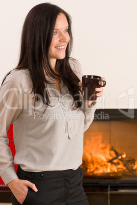 Winter home fireplace woman drink hot coffee