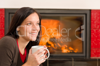 Winter home fireplace woman drink hot coffee