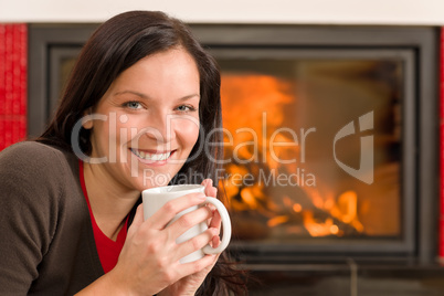 Winter home fireplace woman drink hot coffee