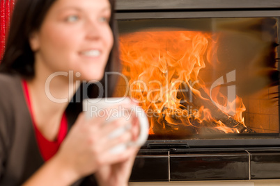 Woman by fireplace home drink
