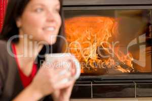 Woman by fireplace home drink