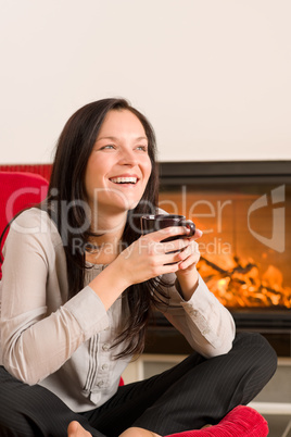 Winter home fireplace woman drink hot coffee