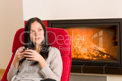 Winter home fireplace woman drink hot coffee
