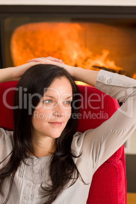 Winter home fireplace woman relax red armchair